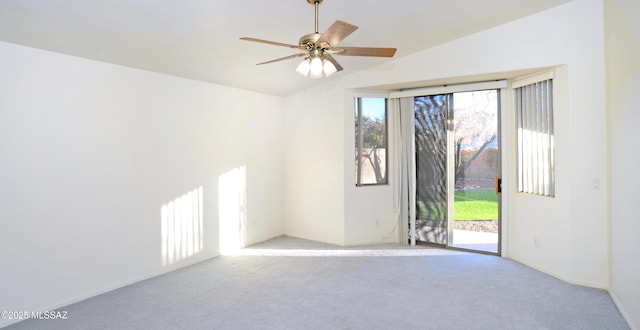 carpeted spare room with ceiling fan and lofted ceiling