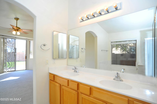 bathroom with vanity, ceiling fan, and a healthy amount of sunlight