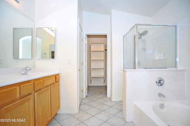 bathroom with tile patterned flooring, vanity, and independent shower and bath