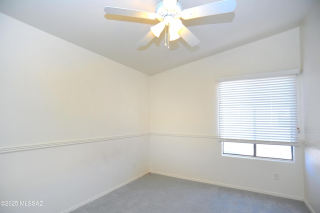 carpeted spare room with a wealth of natural light, ceiling fan, and lofted ceiling