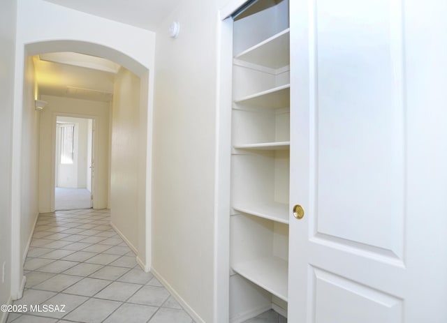 corridor with light tile patterned floors