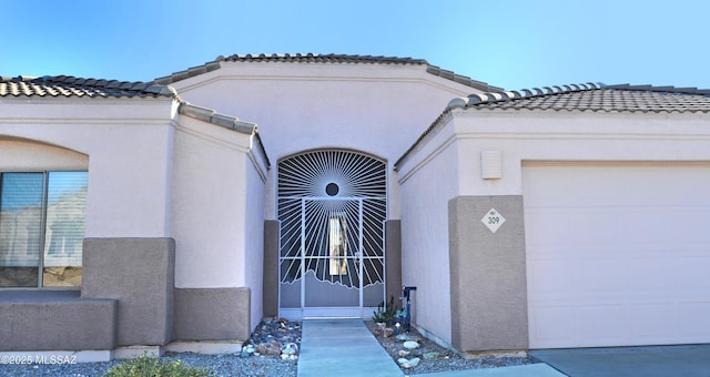 doorway to property with a garage