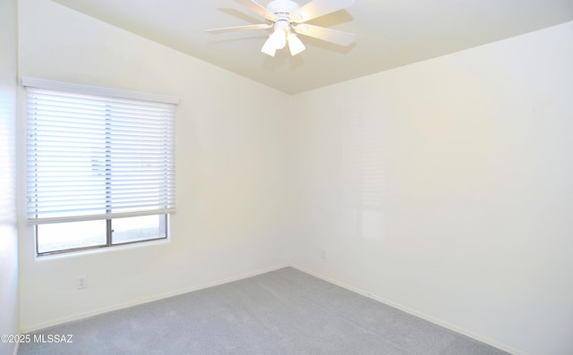 carpeted empty room with vaulted ceiling and ceiling fan