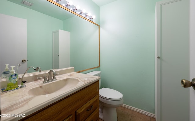 half bath featuring visible vents, baseboards, toilet, vanity, and tile patterned floors