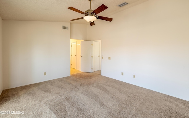 unfurnished room featuring high vaulted ceiling, visible vents, light colored carpet, and ceiling fan