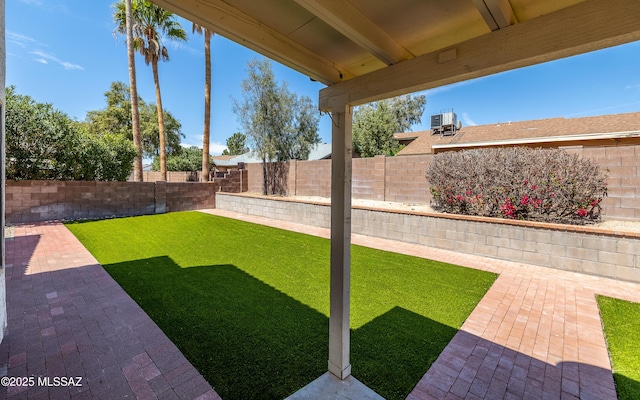 view of yard featuring a patio area, a fenced backyard, and central air condition unit