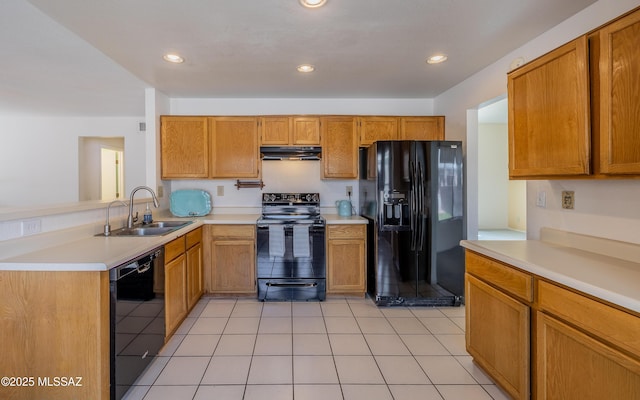 kitchen featuring black appliances, recessed lighting, under cabinet range hood, light countertops, and a sink