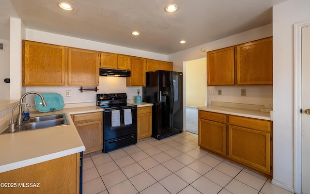 kitchen featuring recessed lighting, light countertops, black appliances, under cabinet range hood, and a sink