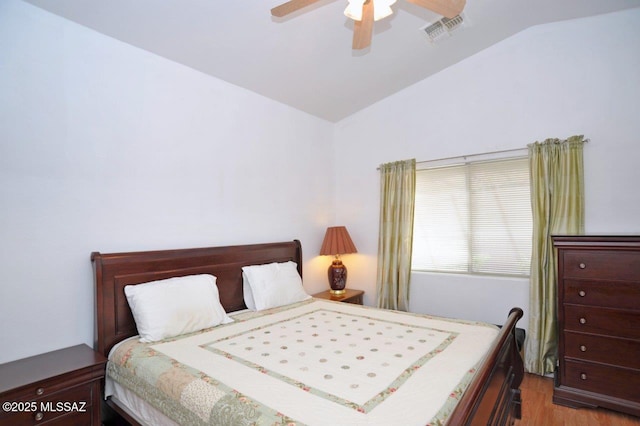 bedroom featuring ceiling fan, vaulted ceiling, and wood-type flooring