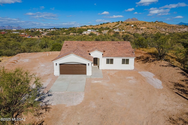 view of front of house featuring a mountain view and a garage