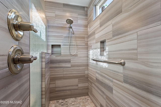 bathroom with a tile shower