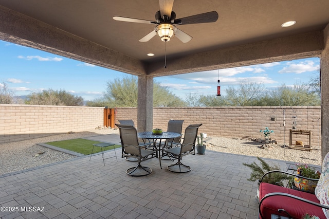 view of patio featuring ceiling fan