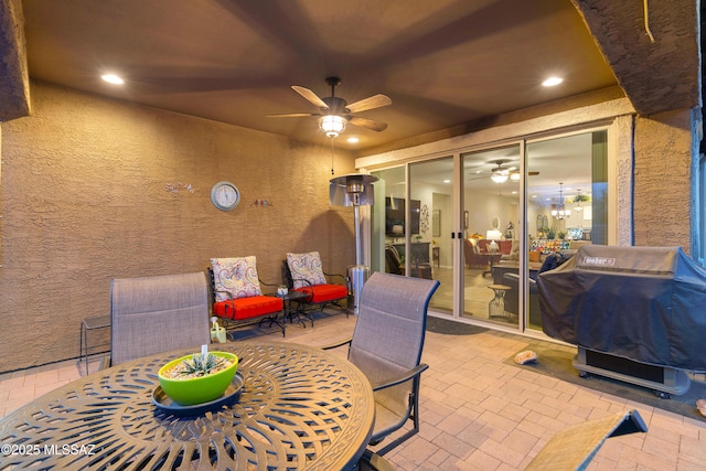 view of patio featuring ceiling fan and a grill