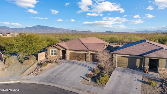 single story home with a garage and a mountain view