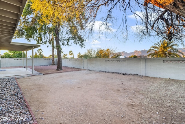 view of yard with a patio and a mountain view