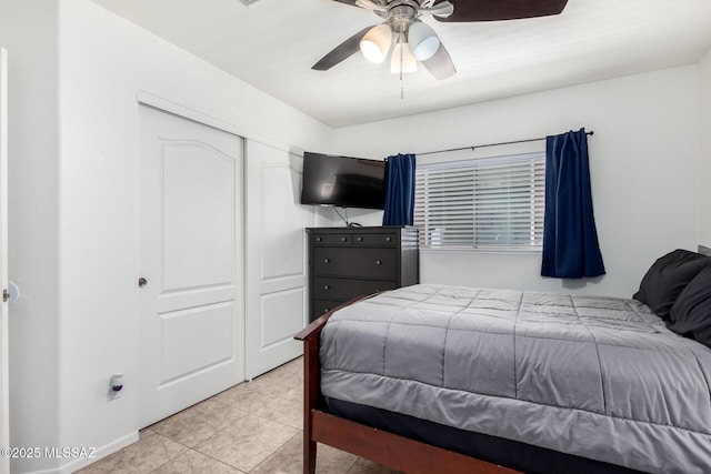 tiled bedroom featuring a closet and ceiling fan