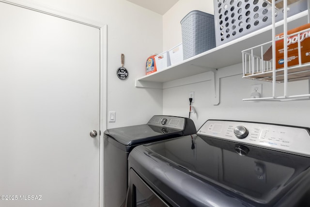 clothes washing area with washing machine and clothes dryer