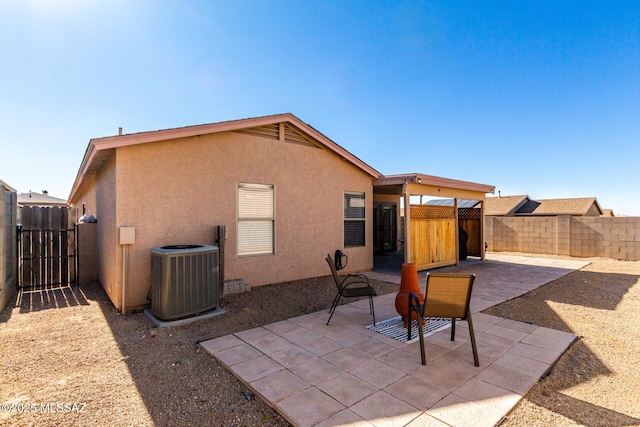 back of house featuring central AC and a patio area