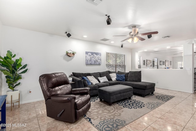 tiled living room with a healthy amount of sunlight and ceiling fan