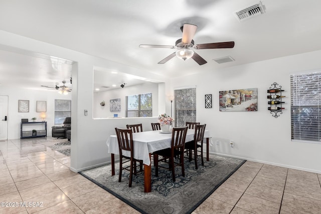 tiled dining space featuring ceiling fan