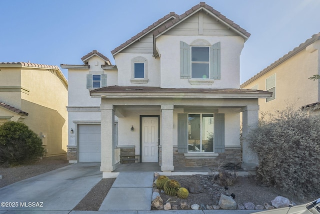 traditional-style home with stone siding, a porch, driveway, and stucco siding