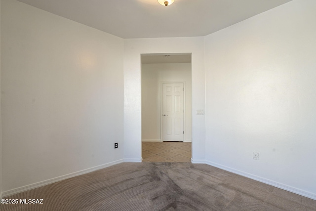 unfurnished room with carpet floors and baseboards