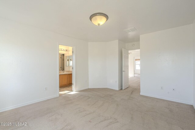 interior space with light carpet, visible vents, and baseboards