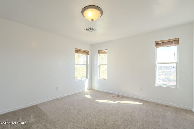 unfurnished room featuring light carpet, baseboards, and visible vents