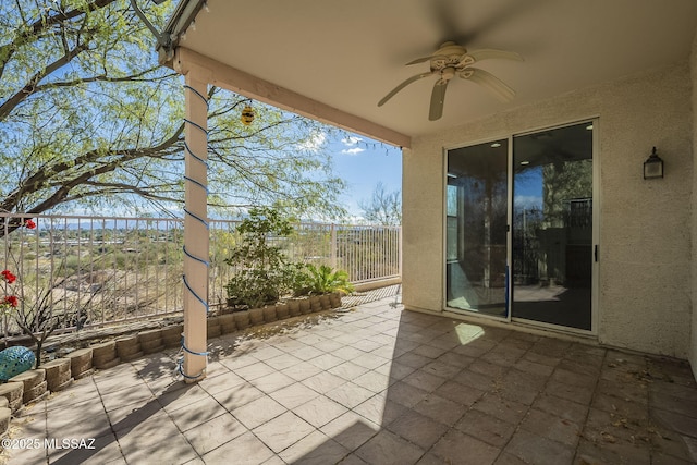 view of patio / terrace with ceiling fan and fence