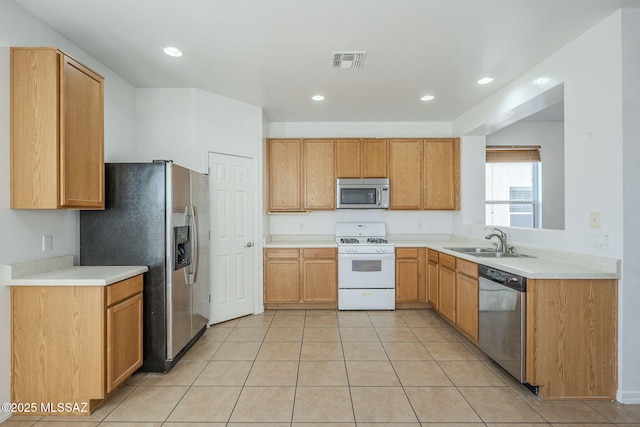 kitchen with light tile patterned floors, recessed lighting, stainless steel appliances, a sink, and visible vents