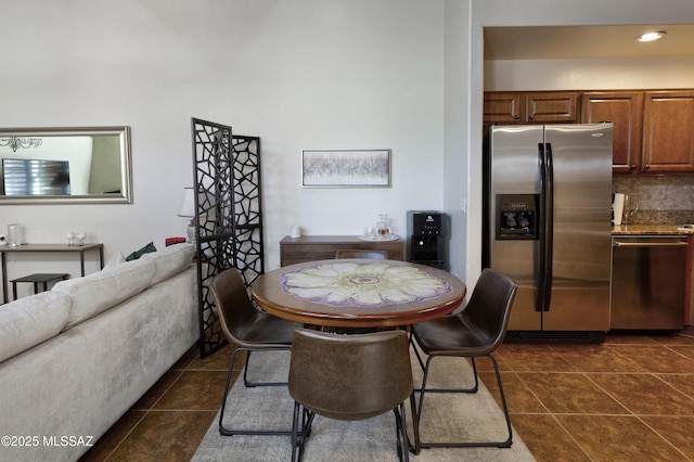 dining space featuring dark tile patterned floors
