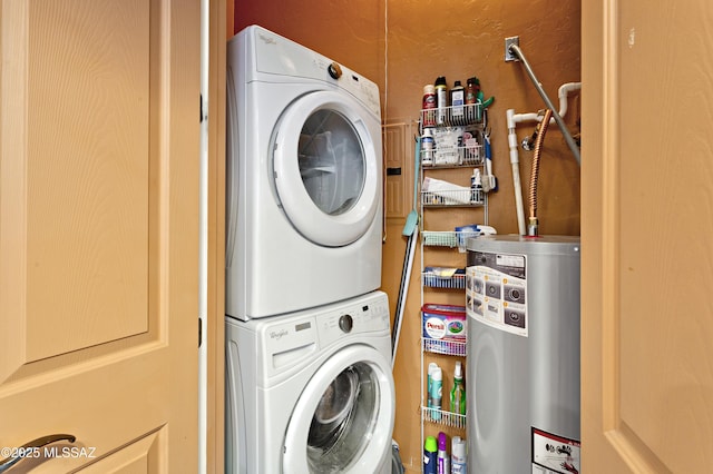 washroom featuring stacked washer / drying machine and gas water heater