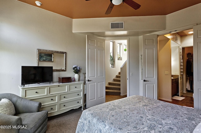 bedroom with ceiling fan and dark carpet