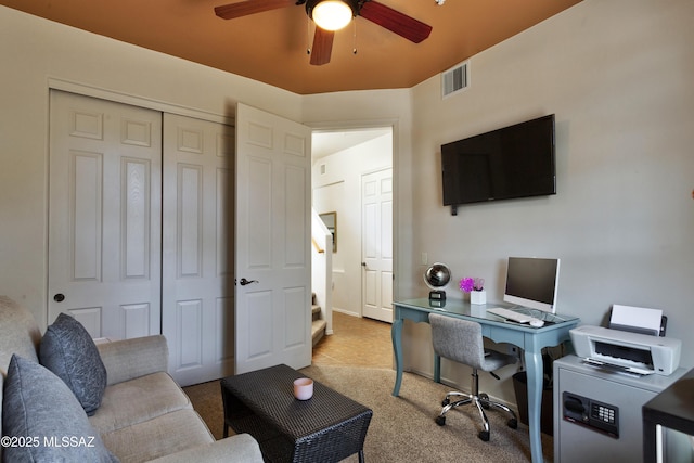 carpeted office space with ceiling fan