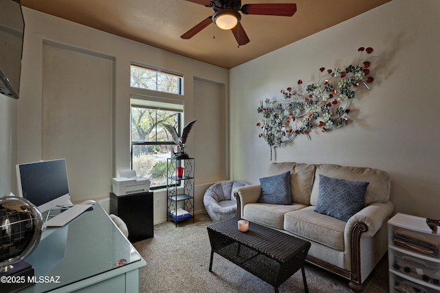 living room with ceiling fan and carpet flooring