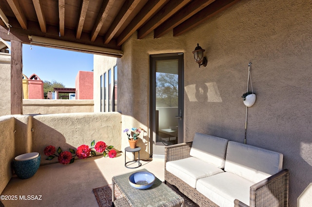 view of patio featuring a balcony