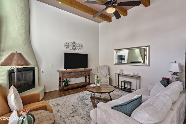 living room with beam ceiling, ceiling fan, and light tile patterned flooring