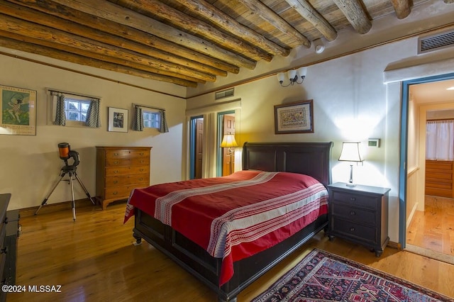 bedroom with beam ceiling, wooden ceiling, and wood-type flooring