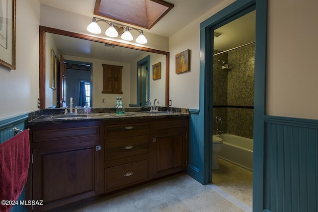 full bathroom featuring vanity, toilet, and tiled shower / bath combo