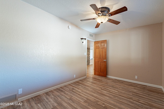 unfurnished room featuring hardwood / wood-style floors and ceiling fan