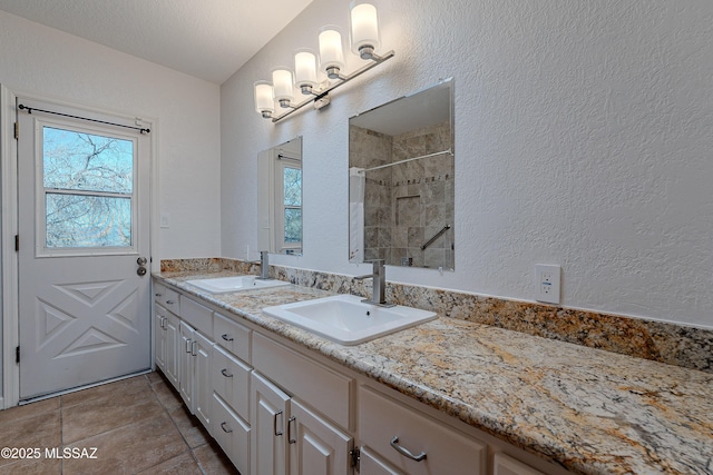 bathroom featuring a textured ceiling and vanity