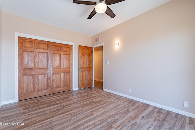 unfurnished bedroom featuring ceiling fan, a closet, and light hardwood / wood-style floors