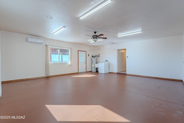 garage with a wall mounted air conditioner, electric water heater, ceiling fan, and washing machine and clothes dryer