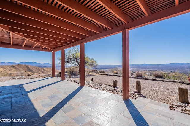 view of patio / terrace featuring a mountain view