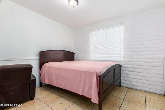 tiled bedroom with brick wall