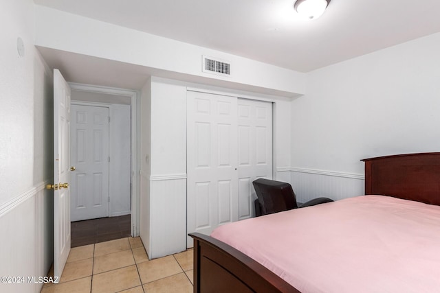 tiled bedroom with a closet