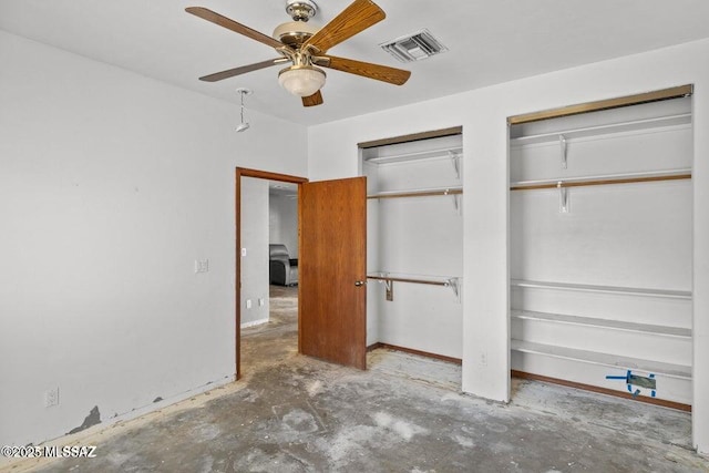 unfurnished bedroom with concrete floors, two closets, and ceiling fan