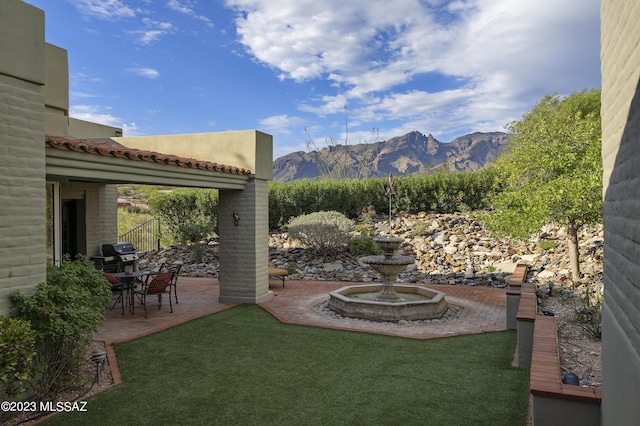 view of yard featuring a mountain view and a patio area