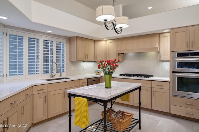 kitchen with appliances with stainless steel finishes, light brown cabinetry, sink, and custom range hood