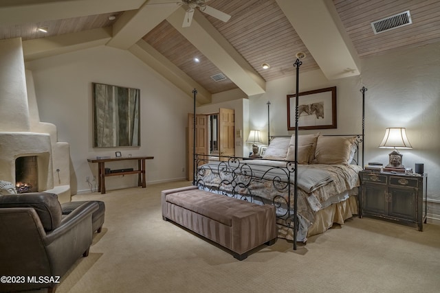 bedroom with lofted ceiling with beams, light colored carpet, and wood ceiling